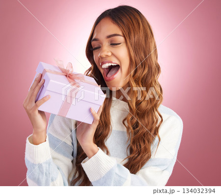 Woman, gift and box in studio for thinking, happiness and surprise celebration by gradient background. Student girl, young and happy with present package, excited face and celebrate birthday with wow Woman, gift and box in studio for thinking, happiness and surprise celebration by gradient background. Student girl, young and happy with present package, excited face and celebrate birthday with wow 134032394
