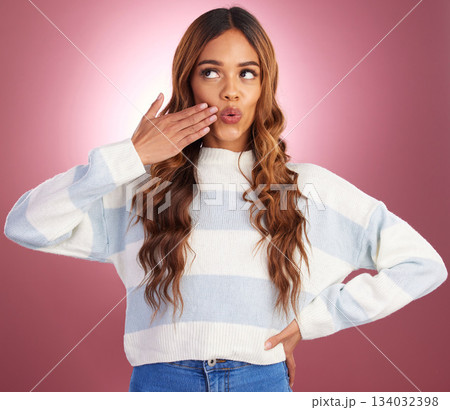 Thinking, hand gesture and funny face with a woman on a pink background in studio feeling silly or goofy. Idea, comedy and comic with an attractive young female having fun or joking about humor 134032398