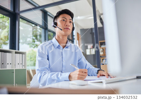 Call center, writing and focus with business man in office for consulting, contact us and telemarketing. Communication, customer service and help desk with Asian employee for receptionist and advice 134032532