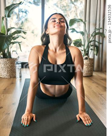 Yoga meditation, cobra stretch and woman in home for health, wellness and flexibility exercise. Pilates, workout and female yogi stretching, holistic training and exercising in house for fitness. Yoga meditation, cobra stretch and woman in home for health, wellness and flexibility exercise. Pilates, workout and female yogi stretching, holistic training and exercising in house for fitness. 134032536