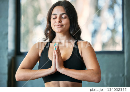 Yoga meditation, prayer hands and woman in home for health, wellness and exercise. Pilates, zen chakra and calm female yogi meditate with namaste for holistic training, peace and mindfulness workout. 134032555