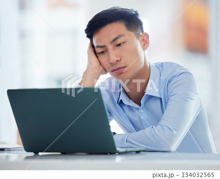 Mental health, businessman tired and worried a with laptop at his desk in a modern workplace office. Fatigue or burnout, problem or mistake and male person sad or stress at his workstation at work Mental health, businessman tired and worried a with laptop at his desk in a modern workplace office. Fatigue or burnout, problem or mistake and male person sad or stress at his workstation at work 134032565