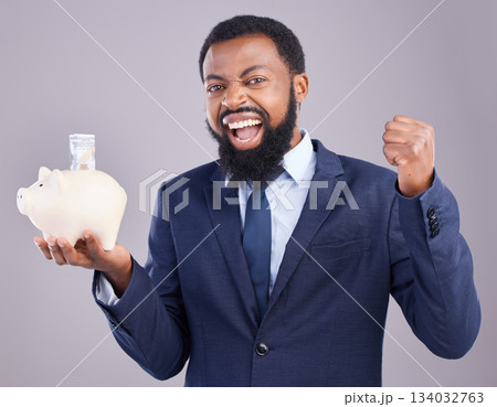 Black man, piggy bank and celebration for financial investment or savings against white studio background. Portrait of excited African businessman holding cash or money pot for winning and investing 134032763