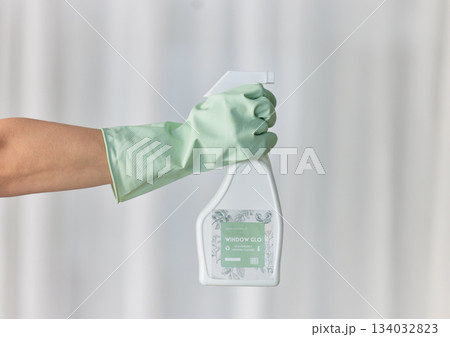 Hands, gloves and housekeeping with detergent spray bottle for spring cleaning, disinfection or dirt removal at home. Hand of cleaner holding sanitizer and rubber glove for clean hygiene or disinfect Hands, gloves and housekeeping with detergent spray bottle for spring cleaning, disinfection or dirt removal at home. Hand of cleaner holding sanitizer and rubber glove for clean hygiene or disinfect 134032823