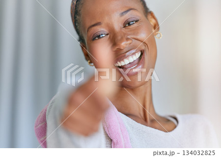Portrait, thumbs up and cleaning with a black woman housekeeper in a home for hygiene or service. Face, motivation and hand gesture with a female cleaner closeup in a house feeling like a winner 134032825