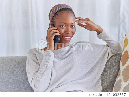 Black woman, portrait and phone call on home sofa with a smile for communication and connection. Female model with a smartphone for conversation with network and contact on living room couch to relax Black woman, portrait and phone call on home sofa with a smile for communication and connection. Female model with a smartphone for conversation with network and contact on living room couch to relax 134032827
