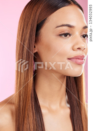 Face, beauty and hair of a woman in studio for salon, cosmetics or skin shine. Skincare and makeup glow or hairstyle of aesthetic model on a pink background for collagen self care facial and wellness Face, beauty and hair of a woman in studio for salon, cosmetics or skin shine. Skincare and makeup glow or hairstyle of aesthetic model on a pink background for collagen self care facial and wellness 134032993