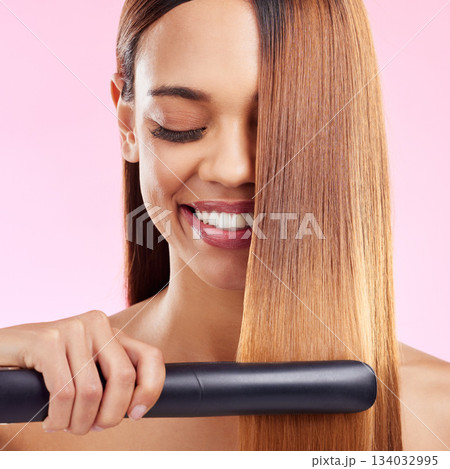 Happy, woman and hair straightener for beauty, salon treatment and girl on studio background. Female, lady and tool for cosmetics, texture and volume with grooming, shine and glow with smile and spa Happy, woman and hair straightener for beauty, salon treatment and girl on studio background. Female, lady and tool for cosmetics, texture and volume with grooming, shine and glow with smile and spa 134032995