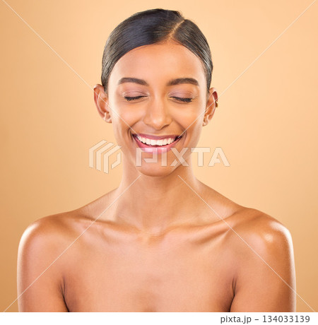 Beauty, face and smile of woman in studio for skincare, cosmetics, dermatology or makeup. Aesthetic female .laughing for self care, natural skin and spa facial shine results on a brown background 134033139