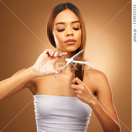 Haircut, woman with scissors and beauty, hair care and tools with serious person on brown background. Cosmetics shine, split ends treatment and keratin with cosmetology, female with makeup in studio 134033152