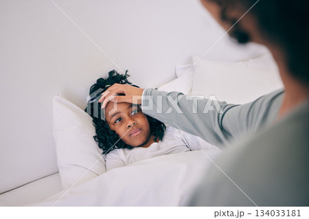 Sick, fever and mother with child in bedroom for illness, care and parenting. Disease, temperature and flu with woman feeling girl forehead in bed of family home for worry, checking and concerned Sick, fever and mother with child in bedroom for illness, care and parenting. Disease, temperature and flu with woman feeling girl forehead in bed of family home for worry, checking and concerned 134033181