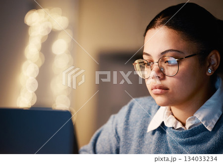 Business, student or concentration laptop in night office on financial software, investment data or mockup growth analytics. Serious, reading and working late woman on technology for finance learning Business, student or concentration laptop in night office on financial software, investment data or mockup growth analytics. Serious, reading and working late woman on technology for finance learning 134033234