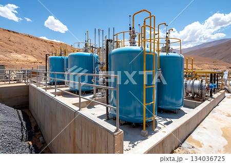 Industrial Storage Tanks in Energy Facility Surrounded by Mountains and Blue Sky Industrial Storage Tanks in Energy Facility Surrounded by Mountains and Blue Sky 134036725