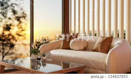 Glass top wooden table and white leather sofa next to glass wall window and sheer curtain in evening Glass top wooden table and white leather sofa next to glass wall window and sheer curtain in evening 134037855