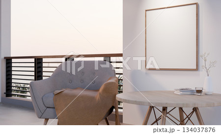 Blank wooden frame hanging on white wall over a wooden table and armchair with blanket near balcony. Blank wooden frame hanging on white wall over a wooden table and armchair with blanket near balcony. 134037876