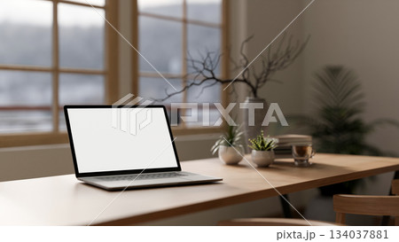 Blank screen computer with a coffee cup, books and decors on wooden table in the cafe or library. 134037881