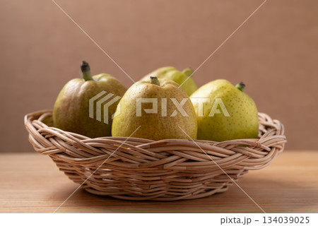 Fresh pear in basket on wooden background Fresh pear in basket on wooden background 134039025
