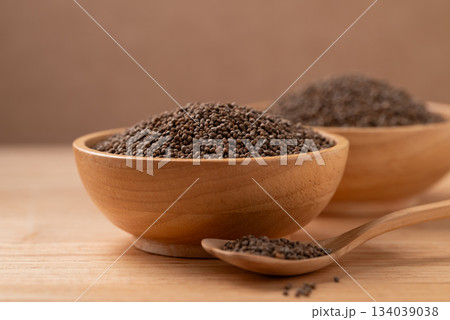 Dried perilla seed in a bowl with spoon on wooden background 134039038