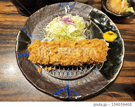 Japanese tonkatsu, a deep-fried pork cutlet, commonly served with shredded cabbage and mustard. 134039408