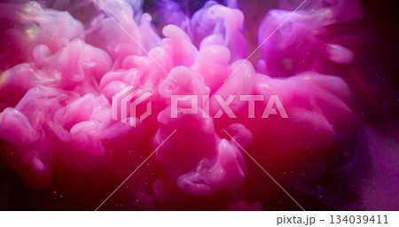 Fume water. Cloud vapor. Defocused pink purple color rainbow ink glitter swirling liquid floating on abstract acrylic art background. 134039411
