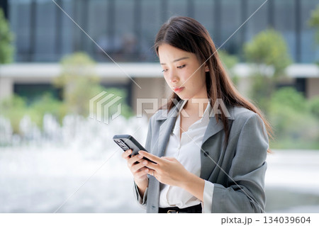 Young asian businesswoman using chatbot or AI message on smartphone. Young asian businesswoman using chatbot or AI message on smartphone. 134039604