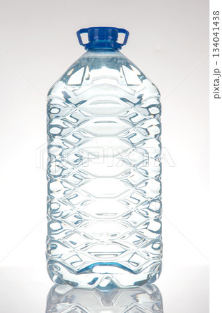 large plastic water bottles with blue caps and textured design 134041438