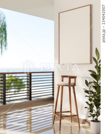 Blank frame hang on white wall over a wooden stool chair at balcony or terrace with scenery outside. 134042007