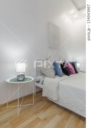 Cozy Bright Bedroom Interior with Soft Pillows and Minimal Decor Cozy Bright Bedroom Interior with Soft Pillows and Minimal Decor 134043667