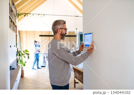 Man using smart home control panel. Man using smart home control panel. 134044102