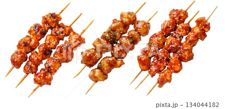 Grilled Korean Dakkochi chicken skewers coated in glossy sesame glaze,isolated on white background, Asian cuisine Grilled Korean Dakkochi chicken skewers coated in glossy sesame glaze,isolated on white background, Asian cuisine 134044182