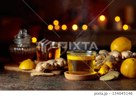 Cup of ginger tea with lemon, honey, mint, and ginger root. 134045146