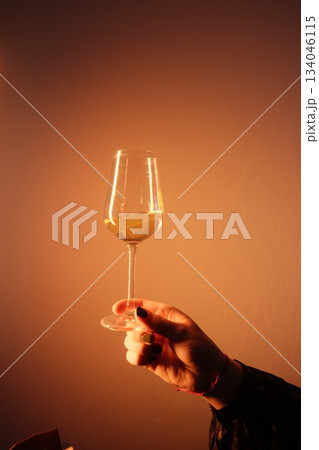 Elegant Hand Holding Sparkling Golden Drink Elegant Hand Holding Sparkling Golden Drink 134046115