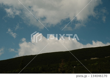 Green Hillside Beneath Dramatic Summer Clouds 134046170