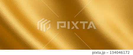 Gold foil background with golden metal shine and soft gradient texture. This gold foil surface adds a glossy golden look, creating a luxurious metal effect for elegant designs 134046172