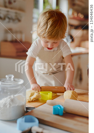 Little boy helping with baking in kitchen. Little boy helping with baking in kitchen. 134046436