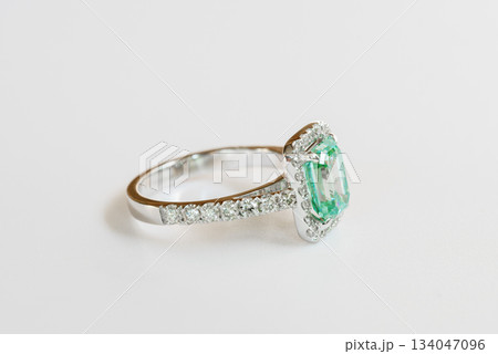 A green and white ring with diamonds and a halo A green and white ring with diamonds and a halo 134047096