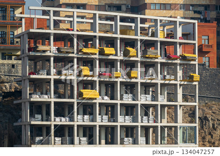 Yerevan Armenia 10.25.2025. A large building with a lot of scaffolding and yellow boards on the side Yerevan Armenia 10.25.2025. A large building with a lot of scaffolding and yellow boards on the side 134047257