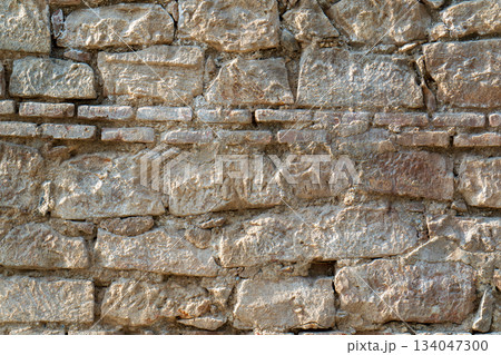 A wall made of stone with a few bricks missing A wall made of stone with a few bricks missing 134047300