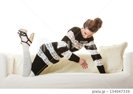 Girl fashionable dress high heels posing on couch. Girl fashionable dress high heels posing on couch. 134047339
