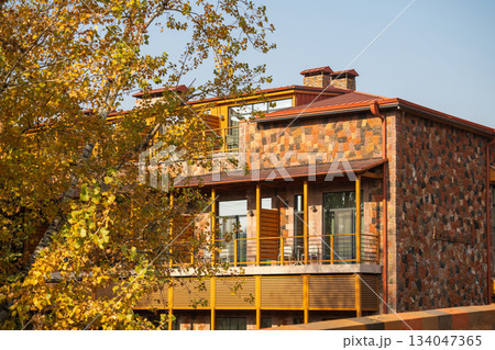 Yerevan Armenia 10.25.2025. A brick building with a balcony and a tree in front of it 134047365