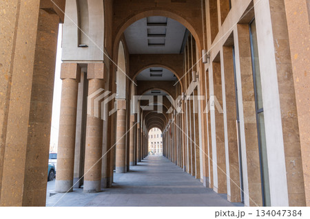 Yerevan Armenia 10.25.2025. A long, narrow hallway with arched windows and pillars 134047384
