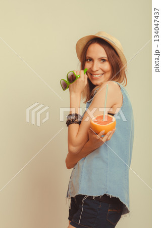 Happy woman in hat drinking grapefruit juice. Diet Happy woman in hat drinking grapefruit juice. Diet 134047437