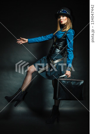 Steampunk girl with retro bag. 134047442