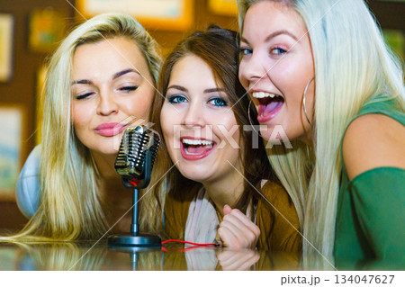 Women singing with microphone Women singing with microphone 134047627