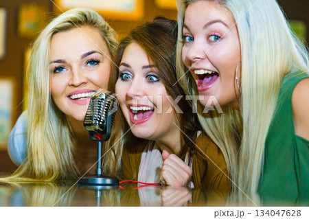 Women singing with microphone 134047628