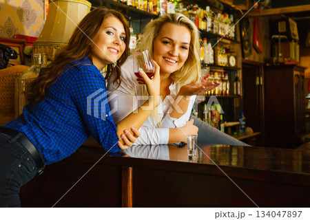 Girls in pub club gossiping and talking 134047897