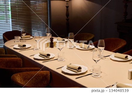 intimate gathering with decorative setting, comfortable dining space with elegant table arrangement intimate gathering with decorative setting, comfortable dining space with elegant table arrangement 134048539