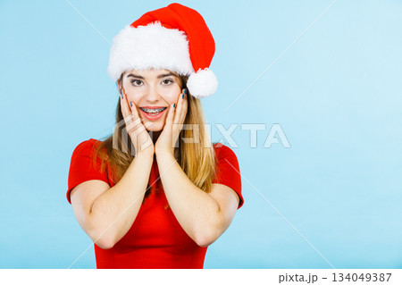 Positive woman wearing Santa Claus helper costume Positive woman wearing Santa Claus helper costume 134049387