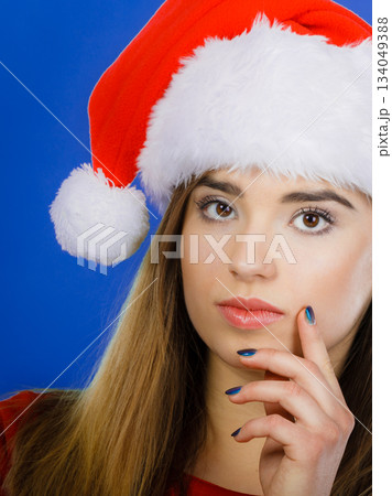Thinking woman wearing Santa Claus helper costume Thinking woman wearing Santa Claus helper costume 134049388