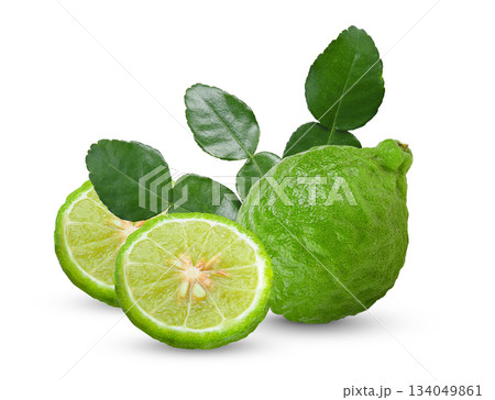 Fresh bergamot or kaffir lime frui and sliuce with leaves on white background. Fresh bergamot or kaffir lime frui and sliuce with leaves on white background. 134049861
